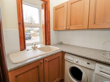 A utility room with a sink washing machine and dishwasher at Barnacre in Longhirst near Morpeth