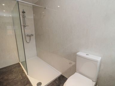 A bathroom with a walk in shower and a toilet at Barnacre in Longhirst near Morpeth