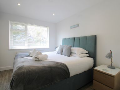 A bedroom with a bed and bedside table at 65 Channel View in Ilfracombe