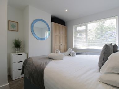 A bedroom with a bed and wardrobe at 65 Channel View Ilfracombe