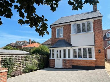 A house with a driveway and garden at The Chocolate Box in Weymouth