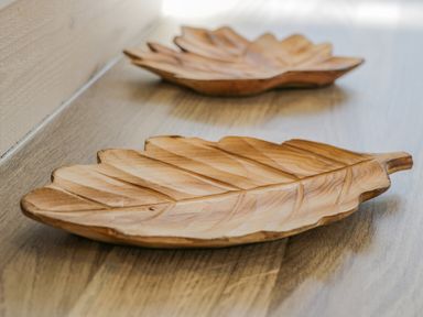 Wooden leaf-shaped trays on a wooden surface at No 27 The Crab Pot Runswick Bay near Staithes