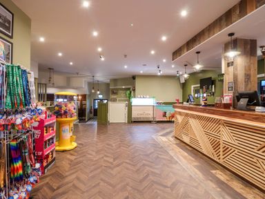 A lobby with a reception desk and gift shop items at Nest Cottage in St Tudy