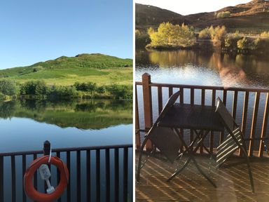 A lake with surrounding green hills seen from a wooden balcony with a life ring and a table with two chairs at Ptarmigan Lodge in Glengoulandie near Aberfeldy