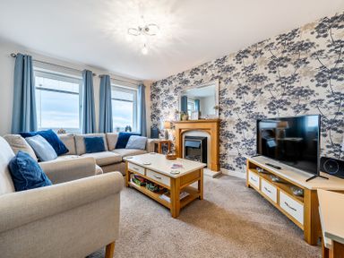 A living room with a sofa and television at Solway View in Skinburness near Silloth