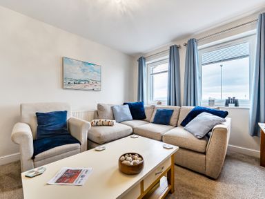 A living room with a sofa and coffee table at Solway View in Skinburness near Silloth