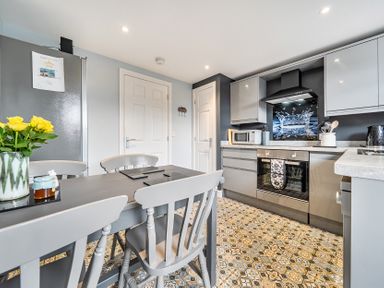 A kitchen with appliances and dining area at Solway View in Skinburness near Silloth