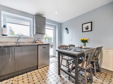 A kitchen with a table and chairs at Solway View in Skinburness near Silloth