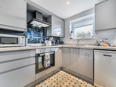 A kitchen with modern appliances and a window at Solway View in Skinburness near Silloth