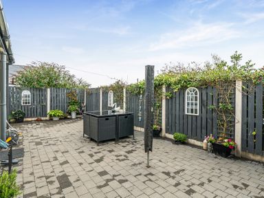 A garden with paving stones and outdoor furniture at Solway View in Skinburness near Silloth