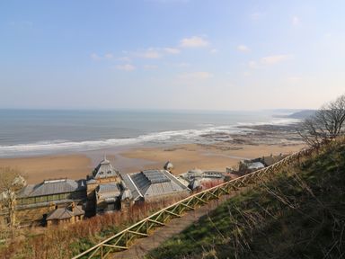 Coastal view with buildings near a beach and a fenced path on a hillside at Chalet 1 in Sherburn