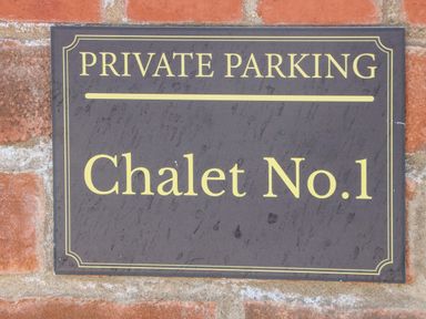 A private parking sign for Chalet No 1 on a brick wall at Chalet 1 Sherburn