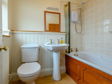 A bathroom with a toilet sink bathtub and shower at Caradoc Tutshill near Chepstow