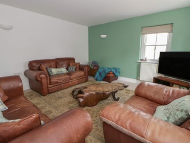 A living room with sofas and a coffee table at Awen Ingli in Newport, Pembrokeshire