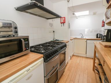A kitchen with appliances including a microwave, toaster, and oven at Awen Ingli Newport, Pembrokeshire