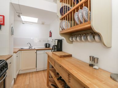 A kitchen with cabinets and utensils at Awen Ingli Newport, Pembrokeshire