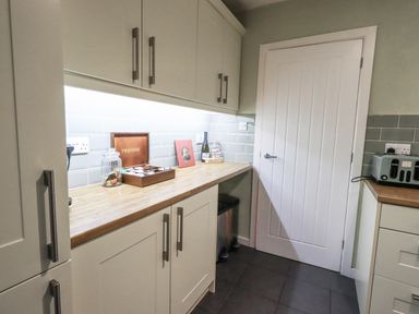 A kitchen with cabinets and a countertop at 8 Beechwood Close in Bowness-On-Windermere