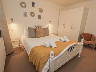 A bedroom with a bed and wardrobe at 8 Beechwood Close Bowness-On-Windermere