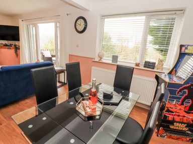 A dining room with a table and chairs at Lake View in Bowness-On-Windermere