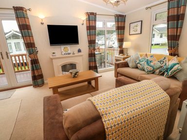 A living room with sofas coffee table and television at 16 Heritage Park Heritage Park near Kilgetty