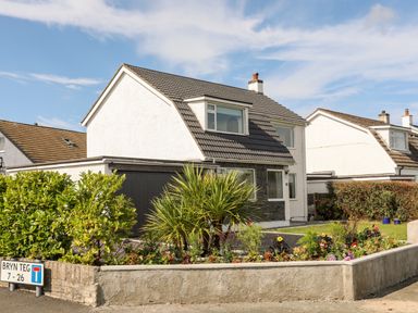 A two-story house with a tiled roof and garden at Dolwyn in Llandegfan