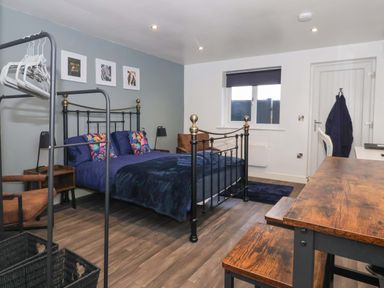 A bedroom with a bed and a desk at Chalet 5 in Sherburn