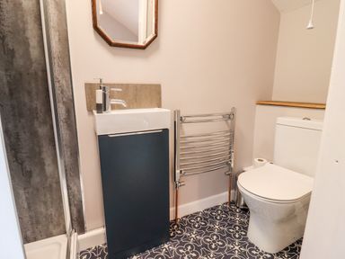 A bathroom with a toilet sink and towel rack at Ley Mill Farm in Huntley