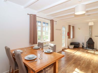 A dining room with a table and chairs at Bracken Cottage in St Tudy
