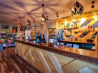 A bar area with a counter and shelves of drinks at Bracken Cottage St Tudy