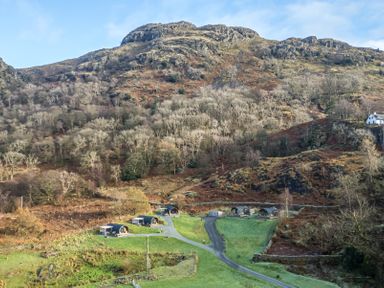 A hillside with small cabins and paths at The Stag - Crossgate Luxury Glamping in Hartsop near Glenridding