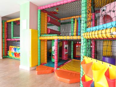 An indoor children's soft play area with climbing frames and padded obstacles at 97 Crugan in Llanbedrog