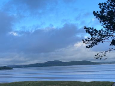 A coastal landscape with water hills and a tree branch in Oversands Cottage Grange-Over-Sands