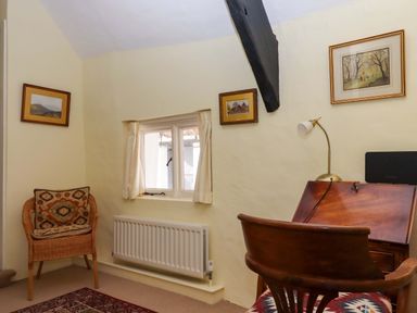 A study with a desk and chair at Fox Hat Cottage in Chagford