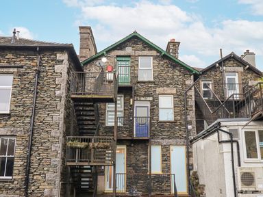 A stone building with multiple staircases and doors at Windermere Crescent in Windermere