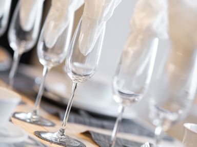 A close up of wine glasses with folded napkins inside on a dining table at Cunsey Mill House Cunsey near Hawkshead