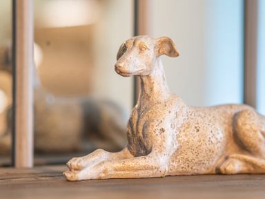 A sculpture of a reclining dog on a wooden surface at Cunsey Mill House Cunsey near Hawkshead