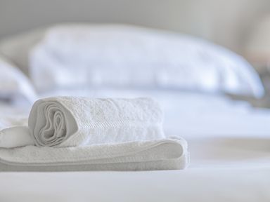 A close up of folded white towels on a bed at Cunsey Mill House Cunsey near Hawkshead