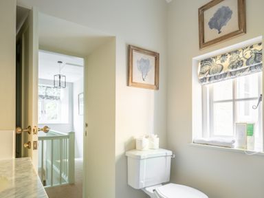 A bathroom with a toilet and window with patterned blind at Cunsey Mill House Cunsey near Hawkshead