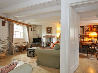 A living room with a sofa and desk at Island House Golant near Tywardreath