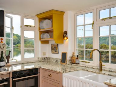 A kitchen with a sink and cabinets at Island House in Golant near Tywardreath
