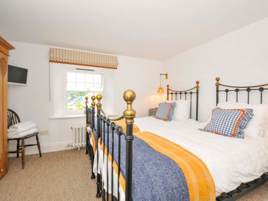 A bedroom with two beds and a window at Island House Golant near Tywardreath