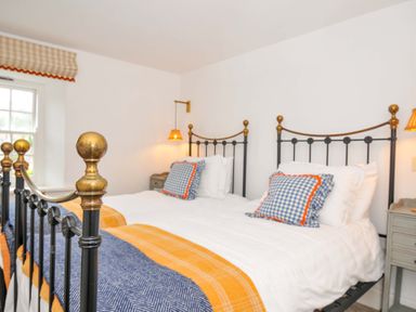 A bedroom with two beds and a window at Island House in Golant near Tywardreath