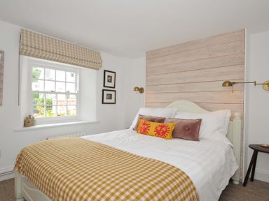 A bedroom with a bed and window at Island House in Golant near Tywardreath