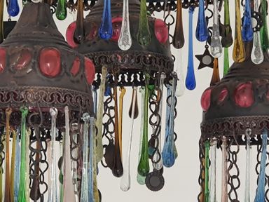 A close up of a metal and glass chandelier with hanging colored glass drops at No 37 in Beverley