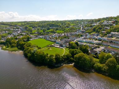 A riverside village with residential houses green fields and trees at Teifi Villa in St Dogmaels