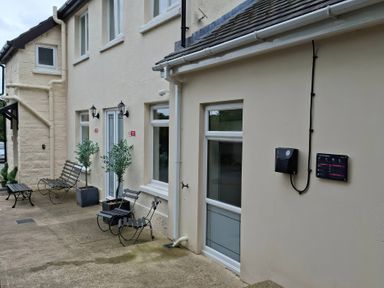 An outdoor area with benches and plants at Teifi Villa St Dogmaels