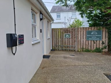 An outdoor area with a gate and a parking sign at Teifi Villa in St Dogmaels