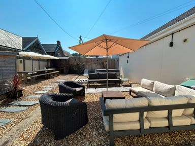 An outdoor seating area with a table and chairs at Teifi Villa St Dogmaels