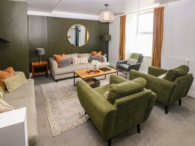 A living room with sofas and a coffee table at Teifi Villa in St Dogmaels