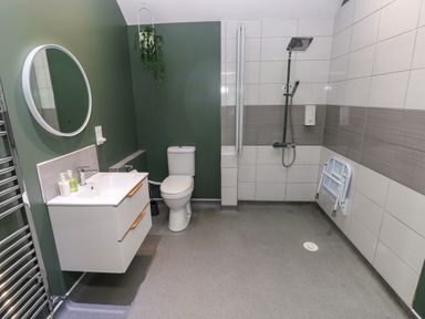 A bathroom with a shower, sink, and toilet at Teifi Villa St Dogmaels